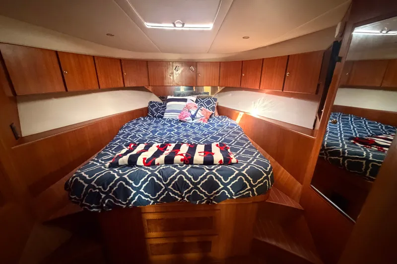 Slide: The Image of Cozy cabin interior of 2002 Seahorse 45 MY yacht with patterned bedding. - 32