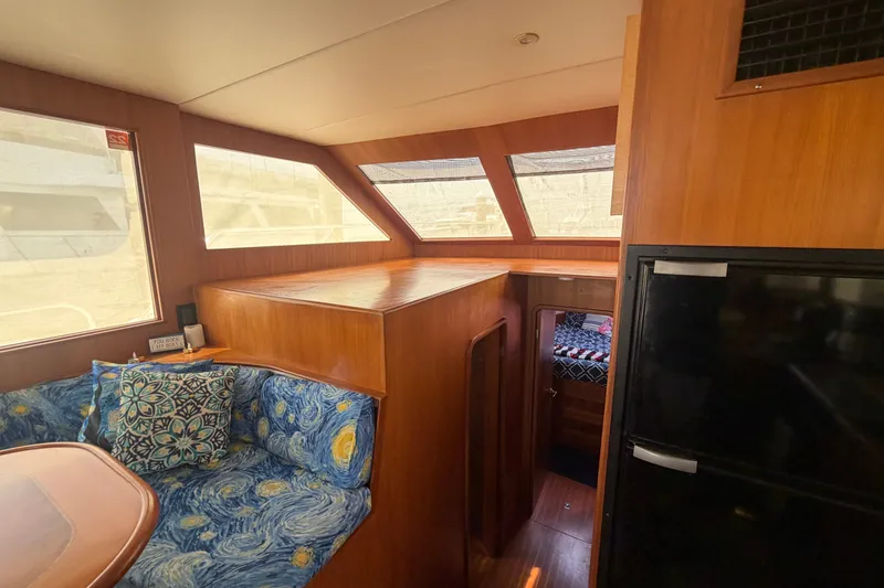 Slide: The Image of Interior of 2002 Seahorse 45 MY yacht with cozy seating and wooden finishes. - 19