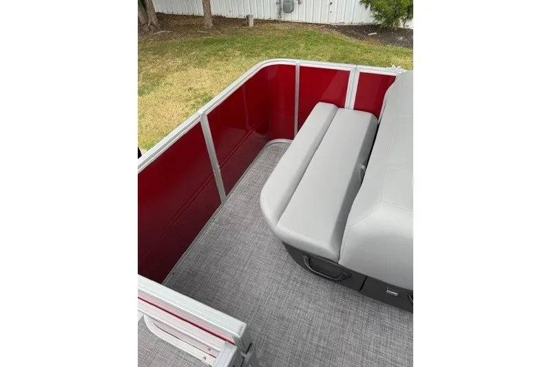 Slide: The Image of 2027 Sun Tracker Party Barge 18 DLX interior with red panels and gray seating. - 14