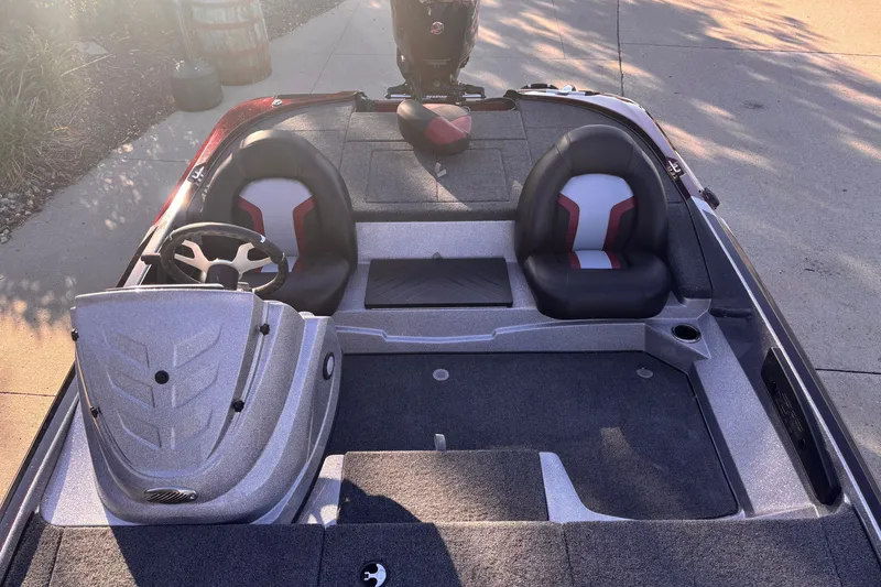 Slide: The Image of 2027 Nitro Z17 boat interior with dual seats and steering wheel, parked on concrete. - 4