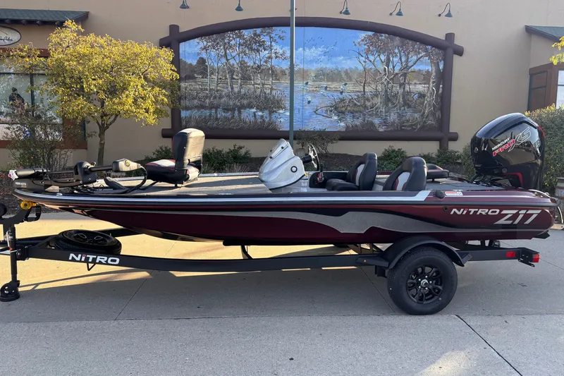 Slide: The Image of 2027 Nitro Z17 boat on trailer, parked outdoors with scenic mural background. - 1