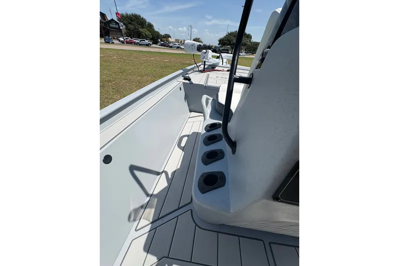 Slide: The Image of 2027 Tracker Bass Tracker Classic CC boat interior with rod holders and seating. - 15