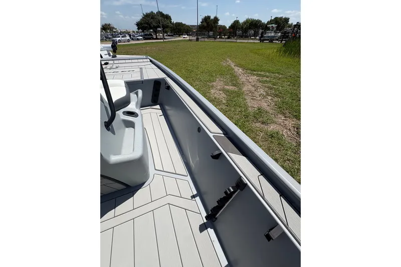 Slide: The Image of 2027 Tracker Bass Tracker Classic CC boat interior with sleek design and rod holders. - 16