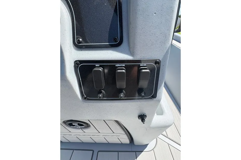 Slide: The Image of Control panel of 2027 Tracker Bass Tracker Classic CC boat with switches for navigation, aerator, and bilge. - 13
