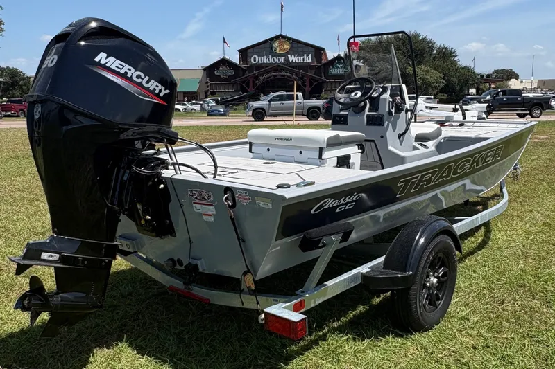 The Image of 2027 Tracker Bass Tracker Classic CC boat with Mercury engine on grassy field. - 0