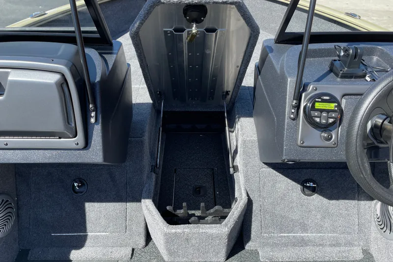 Slide: The Image of 2027 Tracker Pro Guide V-175 WT boat interior with open storage compartment and control panel. - 18