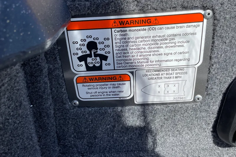 Slide: The Image of Warning label on 2027 Tracker Pro Guide V-175 WT boat about carbon monoxide and propeller safety. - 29