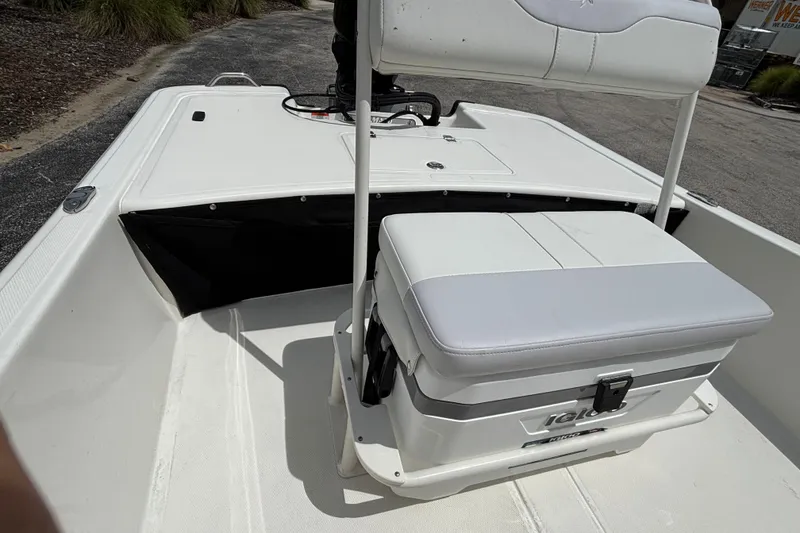 Slide: The Image of 2027 Mako Pro Skiff 17 CC boat interior with seating and storage. - 9