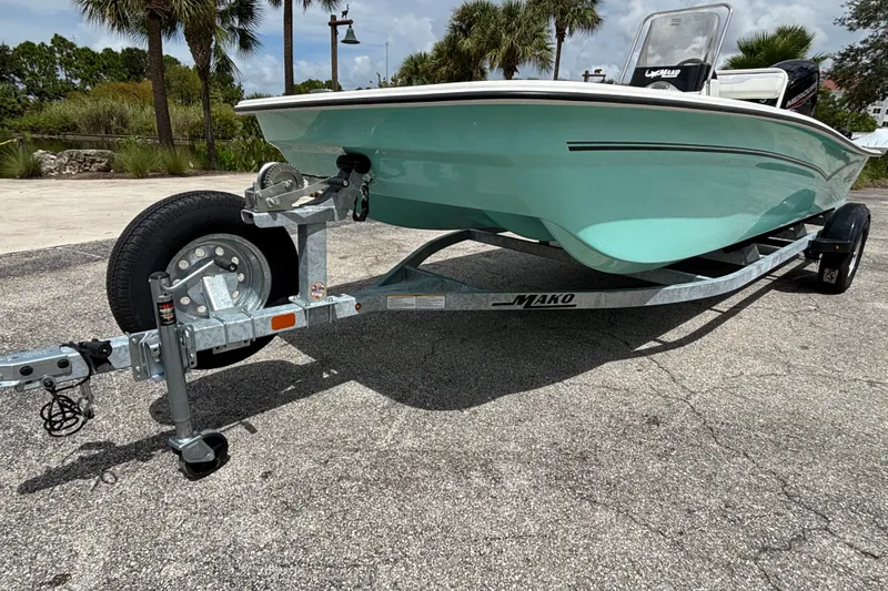 Slide: The Image of 2027 Mako Pro Skiff 17 CC on trailer, parked outdoors. - 1