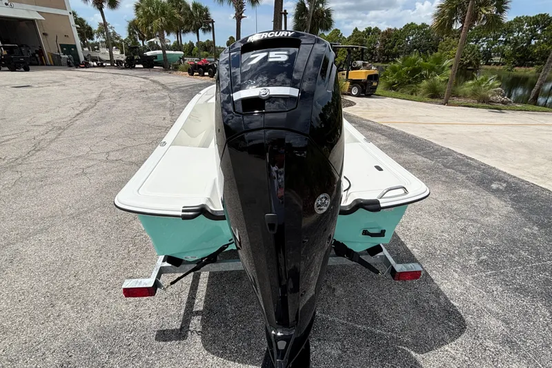 Slide: The Image of 2027 Mako Pro Skiff 17 CC with Mercury 75 engine on trailer, outdoor setting. - 5