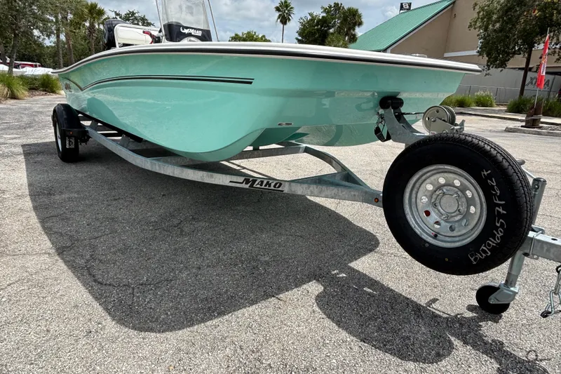 Slide: The Image of 2027 Mako Pro Skiff 17 CC boat on trailer, parked outdoors. - 2