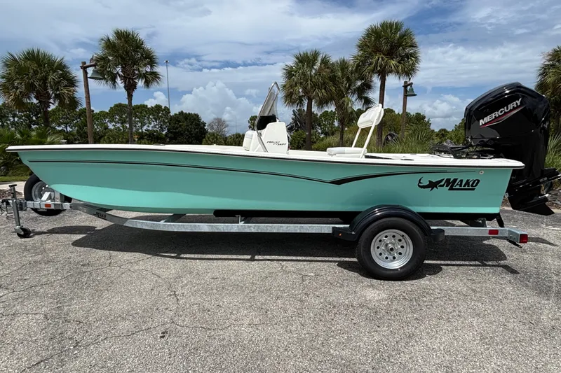 The Image of 2027 Mako Pro Skiff 17 CC boat on trailer, parked with palm trees in background. - 0