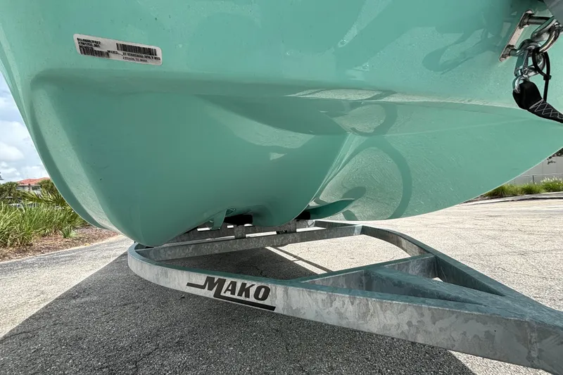 Slide: The Image of 2027 Mako Pro Skiff 17 CC boat on trailer, close-up view of hull. - 3