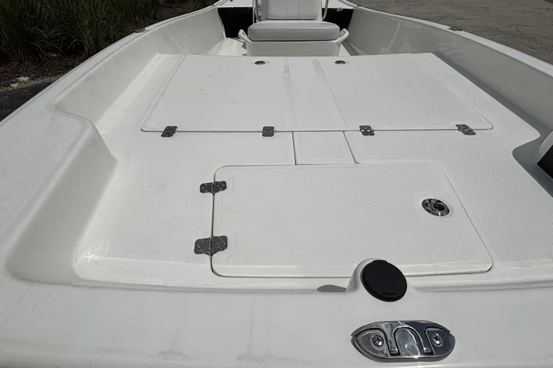 Slide: The Image of 2027 Mako Pro Skiff 17 CC boat deck with storage compartments and seating. - 12