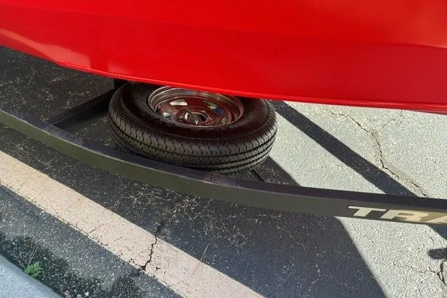 Slide: The Image of Red Tracker Pro Team 175 boat on trailer, showcasing tire and frame, 2026 model. - 16