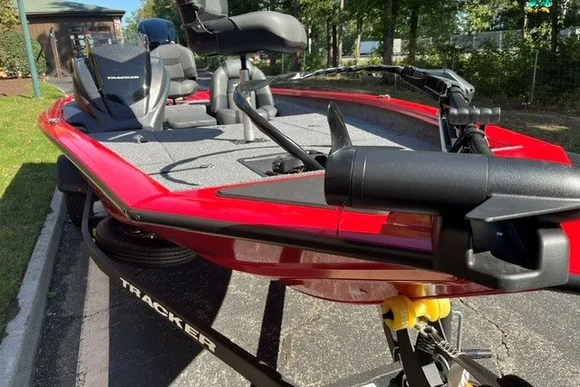 Slide: The Image of 2026 Tracker Pro Team 175 boat in vibrant red, parked on a trailer, ready for adventure. - 14