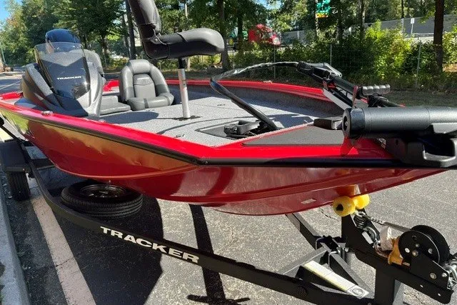 Slide: The Image of 2026 Tracker Pro Team 175 boat in vibrant red on a trailer, parked outdoors. - 13