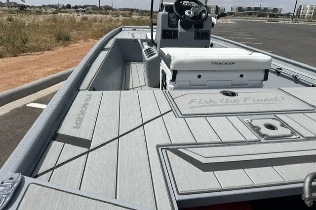 Slide: The Image of 2027 Tracker Bass Tracker Classic CC boat with sleek deck design in a parking area. - 13