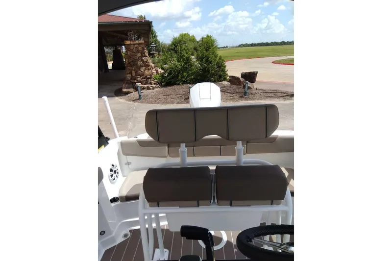 Slide: The Image of 2027 Tahoe 2150 CC boat interior with cushioned seating and steering wheel. - 6