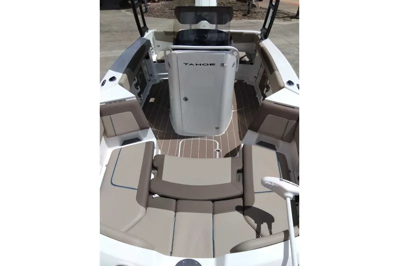 Slide: The Image of 2027 Tahoe 2150 CC boat interior with beige seating and wood-style flooring. - 9