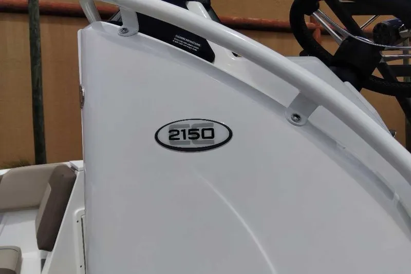 Slide: The Image of 2027 Tahoe 2150 CC boat console with steering wheel and seating. - 7