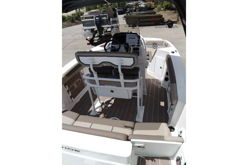 Slide: The Image of 2027 Tahoe 2150 CC boat interior with seating and control console. - 5