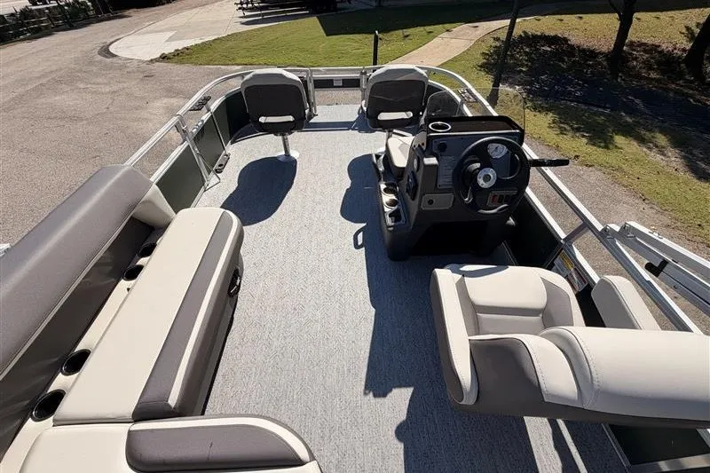 Slide: The Image of 2027 Sun Tracker Bass Buggy 16 XL Select pontoon boat interior with seating and steering console. - 14