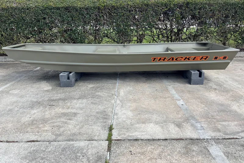 The Image of 2027 Tracker Grizzly 14 Jon boat on concrete blocks, outdoor setting. - 0