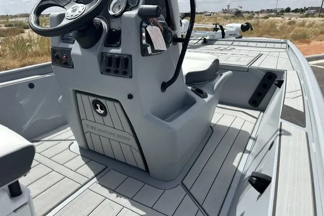 Slide: The Image of 2027 Tracker Bass Tracker Classic CC boat interior with steering console and seating. - 17