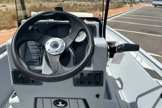 Slide: The Image of Steering console of 2027 Tracker Bass Tracker Classic CC boat in a parking lot. - 15