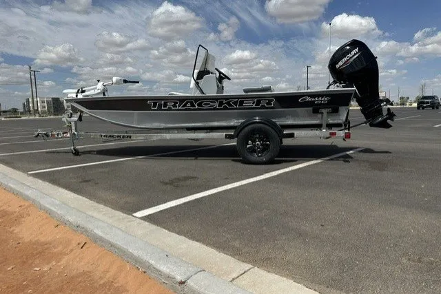 The Image of 2027 Tracker Bass Tracker Classic CC boat parked in a lot under a cloudy sky. - 0
