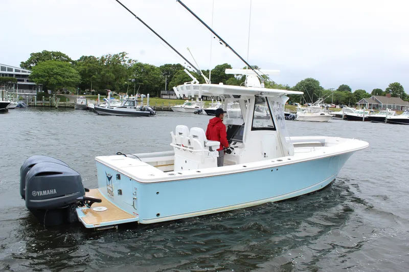 Slide: The Image of 2020 Regulator 28 Forward Seating boat with Yamaha engine on a calm waterway. - 3