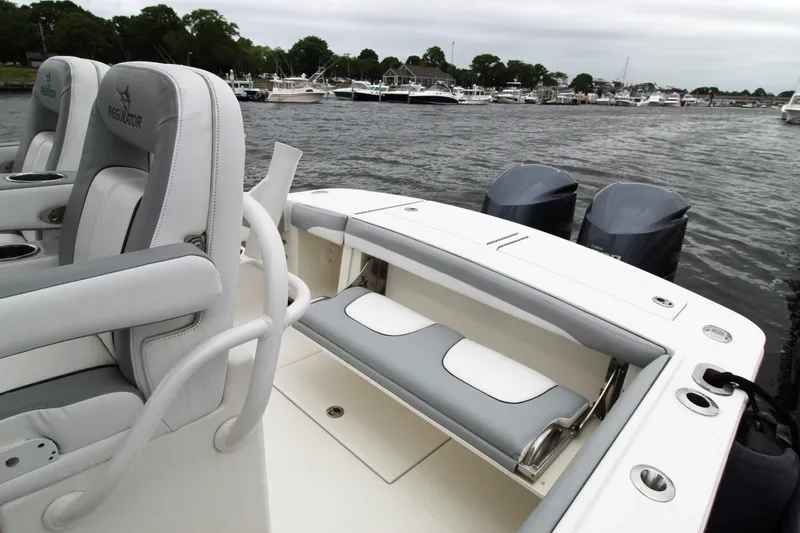 Slide: The Image of 2020 Regulator 28 Forward Seating boat with dual engines, docked in a marina. - 17