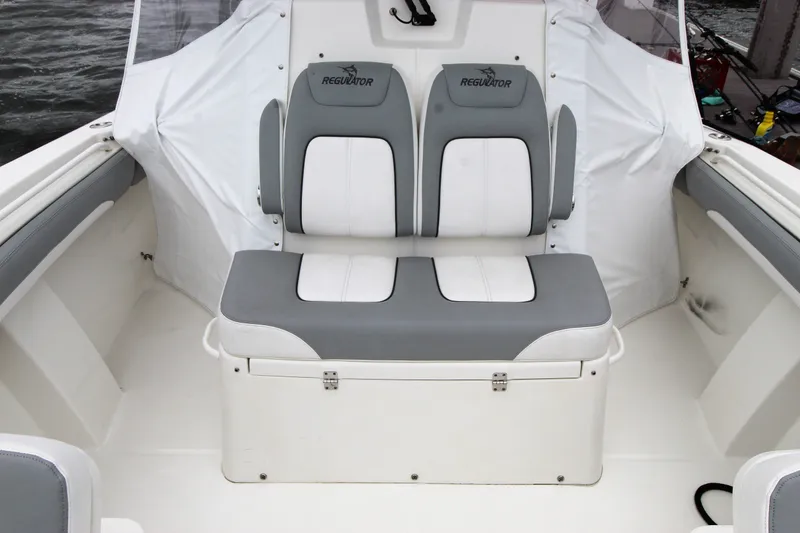 Slide: The Image of 2020 Regulator 28 Forward Seating boat interior with cushioned seats. - 15
