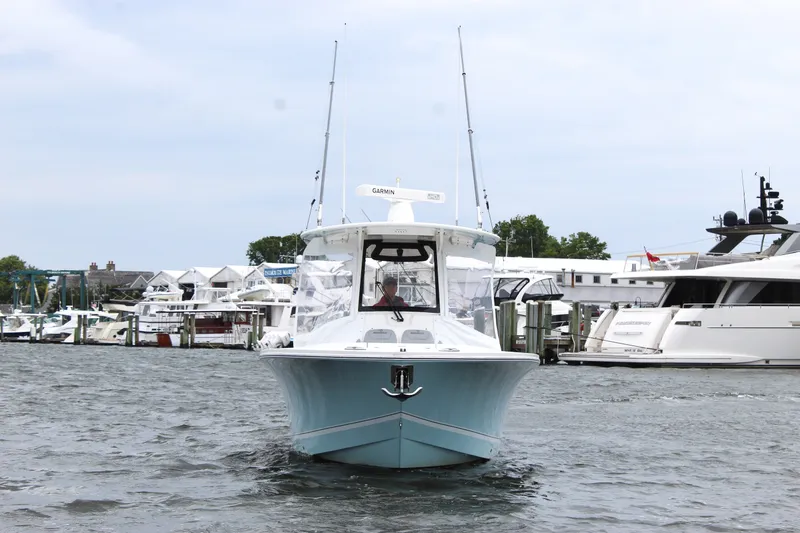 Slide: The Image of 2020 Regulator 28 Forward Seating boat docked in a marina. - 7