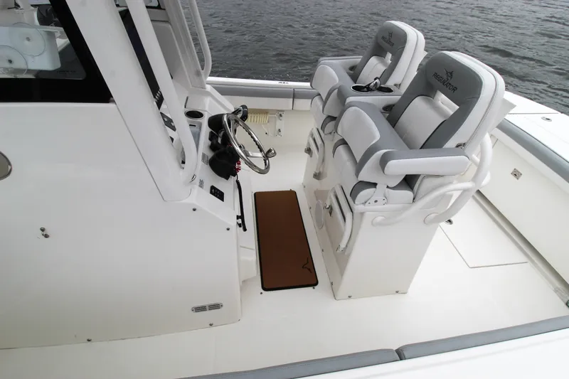 Slide: The Image of 2020 Regulator 28 Forward Seating boat interior with dual helm seats and steering wheel. - 21
