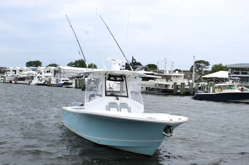 Slide: The Image of 2020 Regulator 28 Forward Seating boat docked in a marina. - 6
