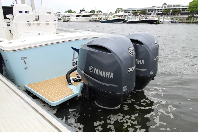 Slide: The Image of 2020 Regulator 28 Forward Seating boat with twin Yamaha 300 engines docked at marina. - 9