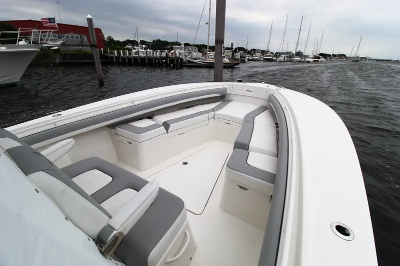 Slide: The Image of 2020 Regulator 28 Forward Seating boat docked, showcasing spacious seating and sleek design. - 12