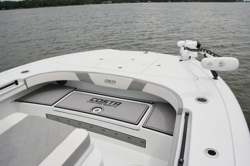 Slide: The Image of 2023 Costa Custom Boats 264 HC bow view on calm water. - 31