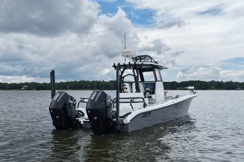 Slide: The Image of 2023 Costa Custom Boats 264 HC on water, featuring dual Mercury engines under cloudy sky. - 19