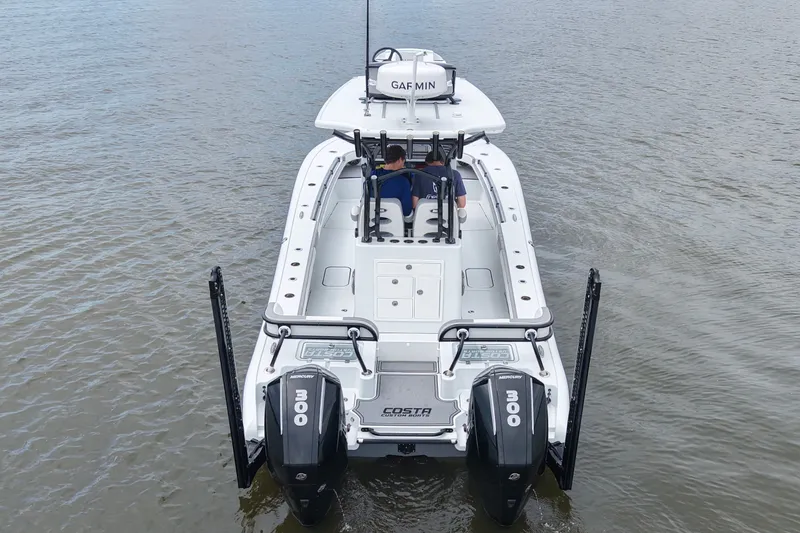 Slide: The Image of 2023 Costa Custom Boats 264 HC on water, featuring dual Mercury engines. - 25