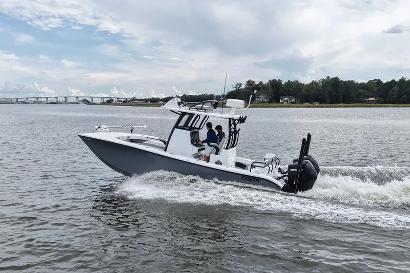 Slide: The Image of 2023 Costa Custom Boats 264 HC cruising on a scenic waterway. - 21
