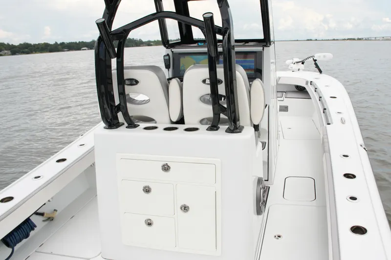 Slide: The Image of 2023 Costa Custom Boats 264 HC interior with helm and seating on calm water. - 47