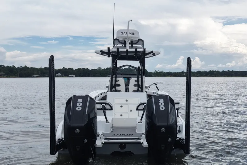 Slide: The Image of 2023 Costa Custom Boats 264 HC with dual 300 horsepower engines on a calm lake. - 18