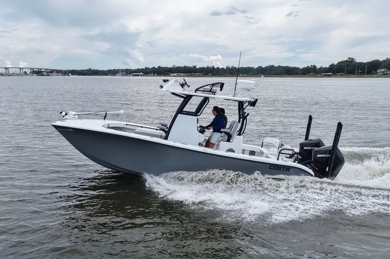 Slide: The Image of 2023 Costa Custom Boats 264 HC cruising on a calm river under a cloudy sky. - 20