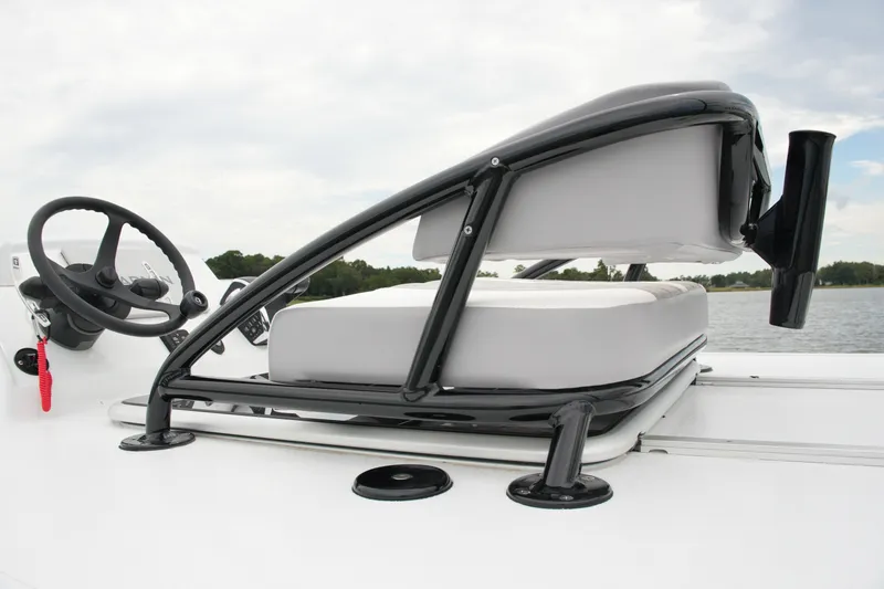 Slide: The Image of 2023 Costa Custom Boats 264 HC helm with steering wheel and cushioned seat. - 63