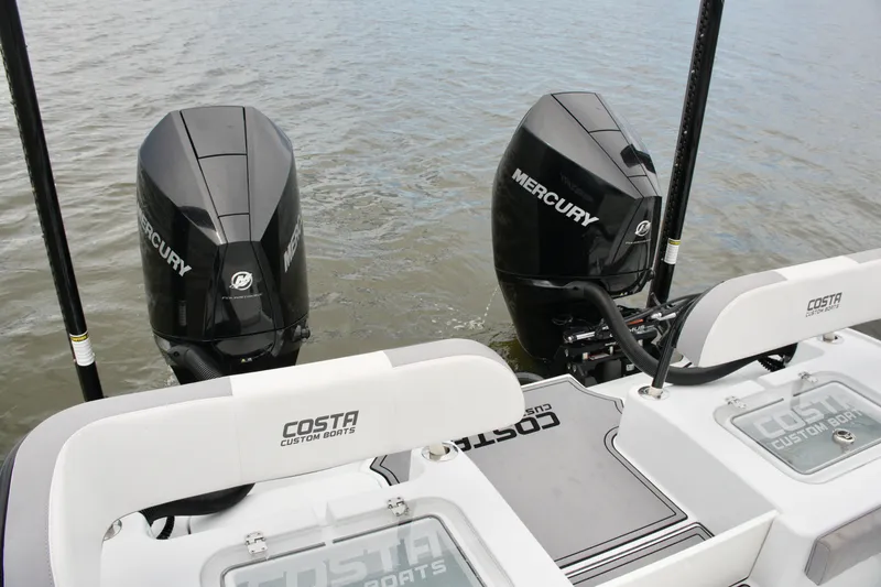 Slide: The Image of 2023 Costa Custom Boats 264 HC with dual Mercury engines on water. - 56