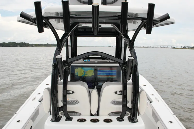 Slide: The Image of 2023 Costa Custom Boats 264 HC, featuring advanced navigation systems on a calm water backdrop. - 52