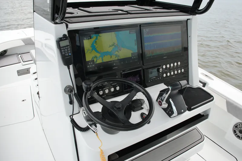 Slide: The Image of 2023 Costa Custom Boats 264 HC helm with dual displays and navigation controls. - 46